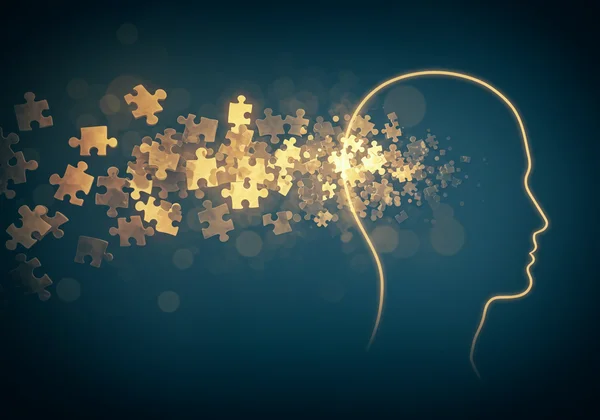 Immagine astratta di pezzi di puzzle che formano un profilo umano.