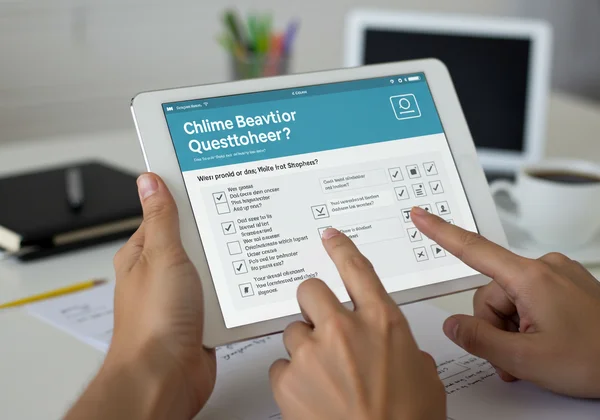 Online RAADS-R assessment interface on a tablet.